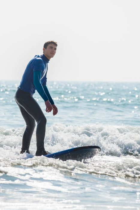 Surfer riding a wave at Tramore Beach